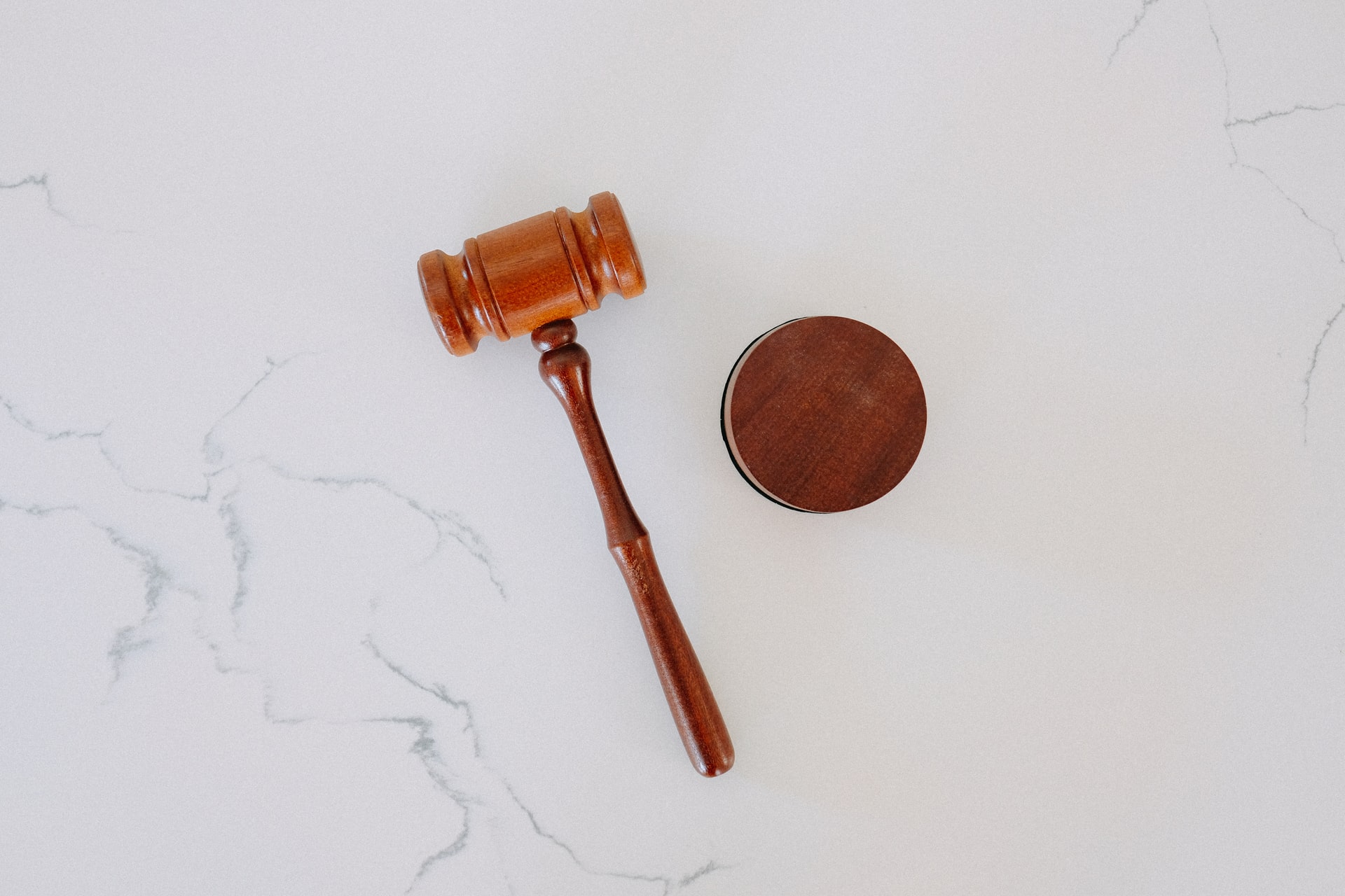 Courtroom gavel on a white marble top